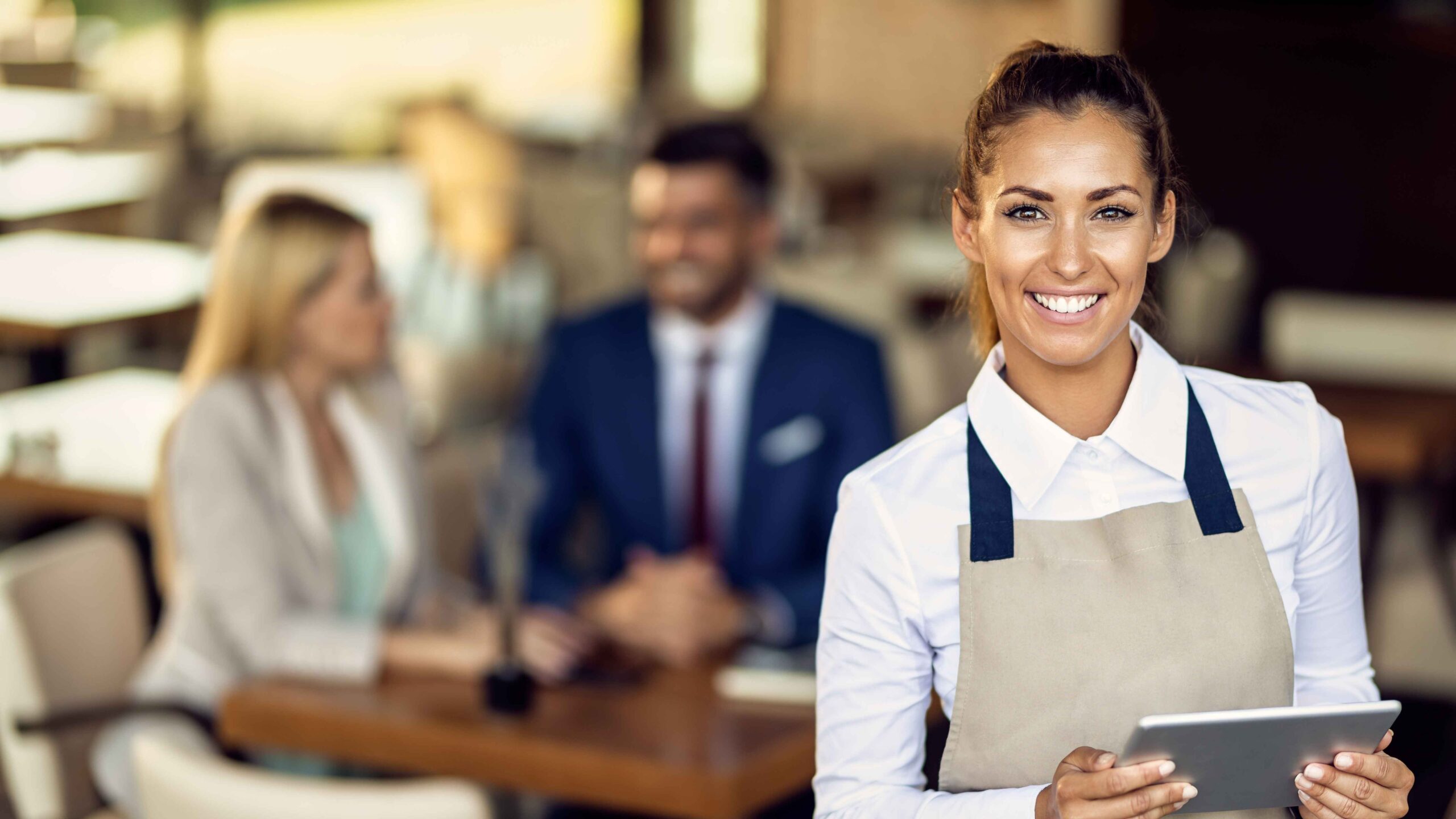 young-happy-waitress-using-touchpad-while-working-cafe (1).jpg